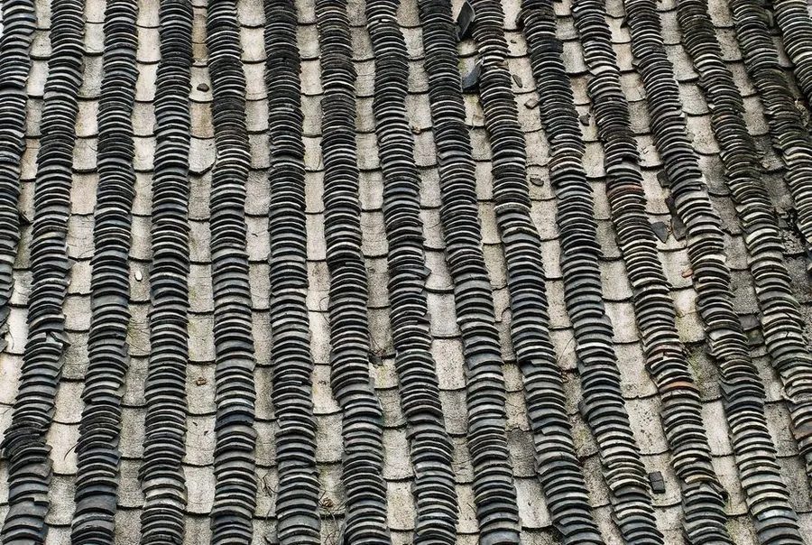 Slipped and broken slate tiles on a roof in need of repair