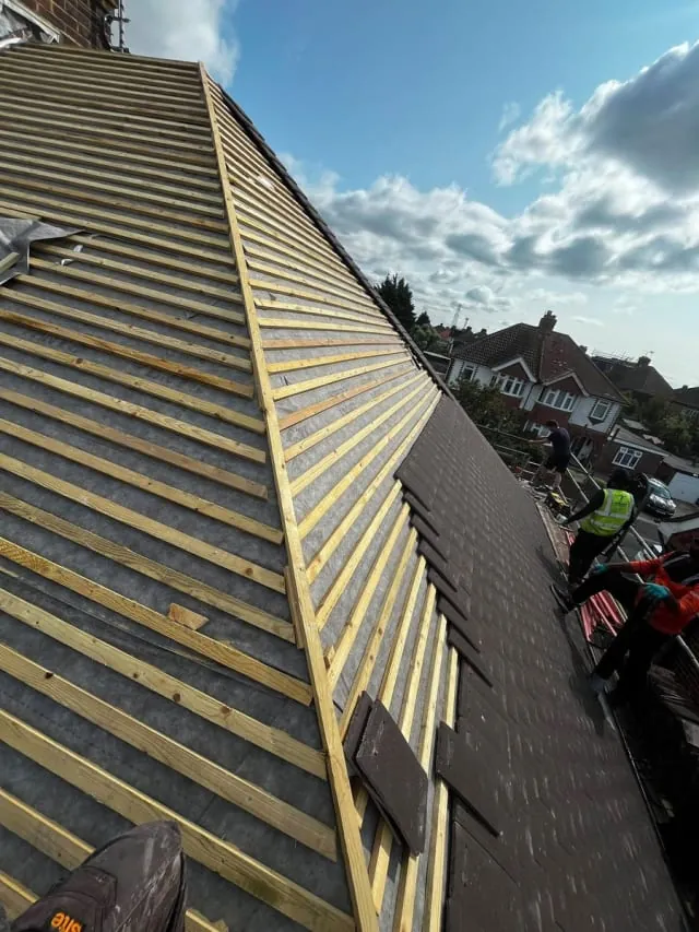 Full re-roof in progress by N Fullers, new tiles going on over fresh battens