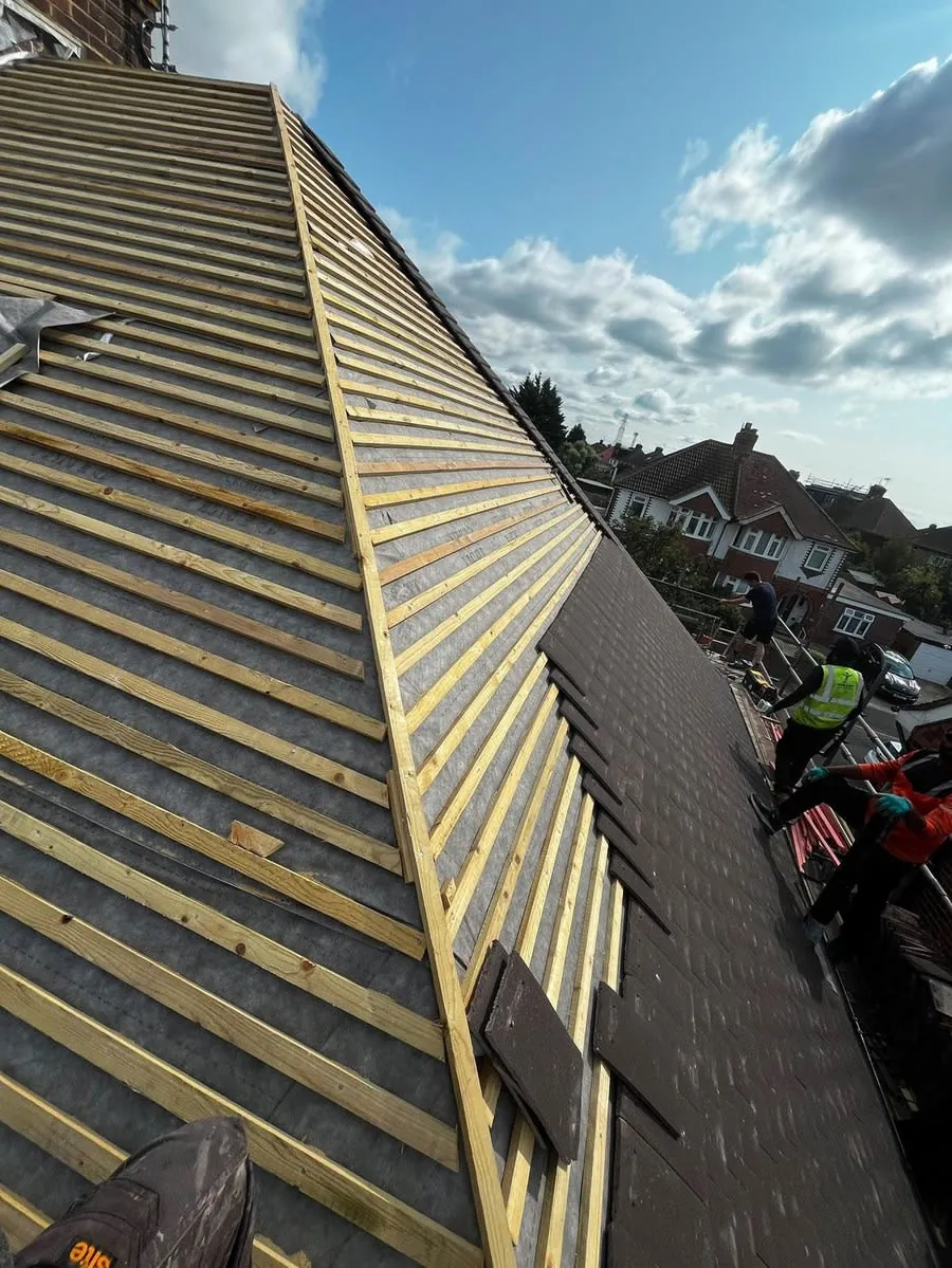 A full re-roof in progress by N Fullers, new tiles going on over fresh battens
