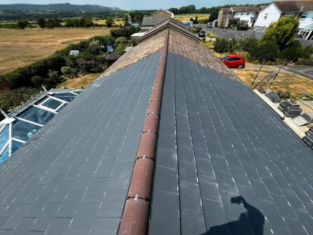 A finished slate roof by N Fullers overlooking the Sussex countryside